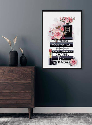 Fashion Brands Plakat featuring stacked books with designer names, roses, lipstick, and perfume on a modern wall.