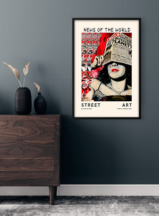 Framed "Street Art - News of the World no.2" poster on a dark wall above a wooden cabinet with vases.