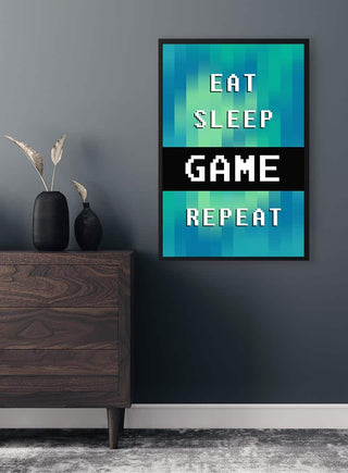 Eat Sleep Repeat Gamer Plakat hanging on a blue wall above a wooden dresser with minimalist decor.