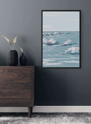 Framed Seascape Plakat artwork with pastel blue and pink tones hanging on a gray wall above a wooden dresser.