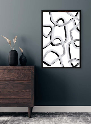 Abstract black and white art print "Make you stay" by Anastasia Sawall on a wall above a dark wooden dresser.
