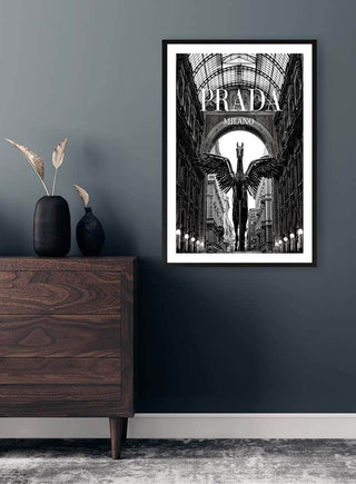 Black-and-white Prada Milano art print on wall above a wooden dresser with minimalist decor.