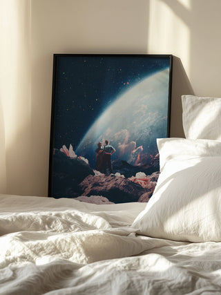 Framed "Often Mistaken for Absent" by Frank Moth resting against a wall beside a sunlit bed.