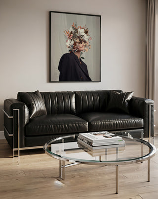 Framed "Infinite Moments Infinite Autumns" artwork by Frank Moth displayed above a modern black leather sofa.