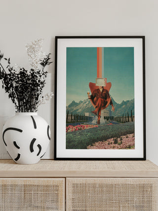 Framed print of Enemy by Frank Moth, surreal collage art with a retro aesthetic, displayed on a modern cabinet.