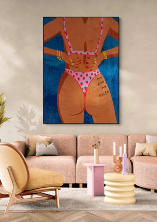 Poster of "My ass my rules" by Raissa Oltmanns displayed above a modern living room sofa.