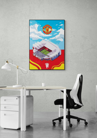 Old Trafford Manchester United stadium poster hanging on a gray wall above a modern office desk and chair.