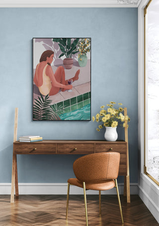 Framed "I Bet You Think About Me - Goed Blauw" art above desk in modern, light blue room with brown chair.