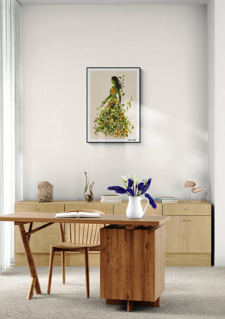 The Garden Muse - Elara Monet art print hanging above a modern wooden home office desk with floral decor.