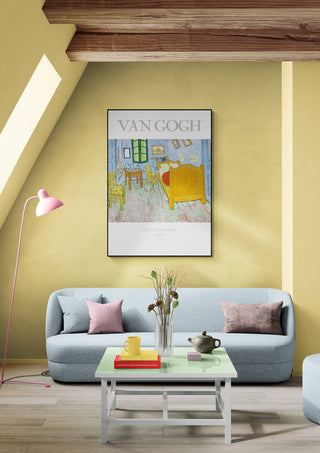 Framed print of Van Gogh’s "The Bedroom" hanging above a modern sofa in a stylish living room.