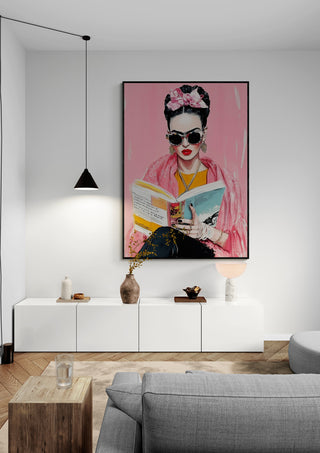 Frida Reading Book wall art displayed above a modern white cabinet in a stylish living room.