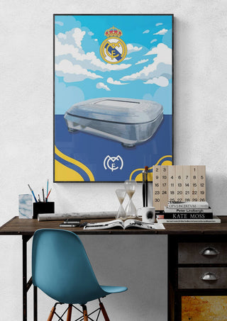 Real Madrid Santiago Bernabeu stadium poster with club crest and blue sky, displayed above a modern desk.